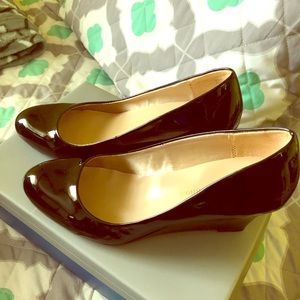 Michael Shannon black patent leather wedge heels.